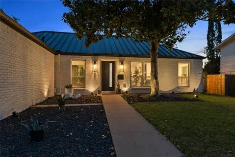 a front view of house with outdoor space and garden