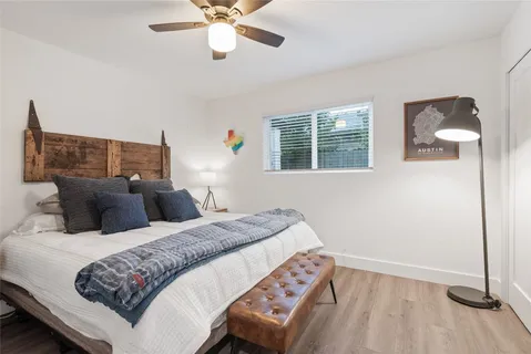 a bedroom with a bed and wooden floor