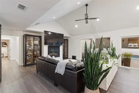 a living room with furniture fireplace and flat screen tv