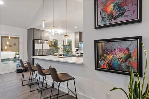 a view of a dining room with furniture a chandelier and wooden floor
