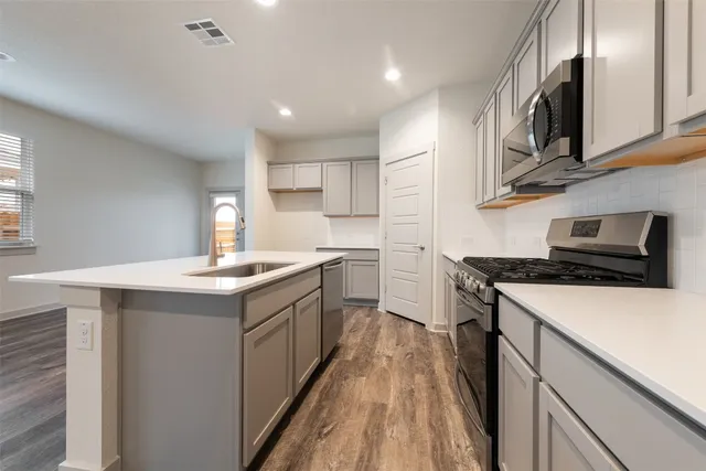 a kitchen with a sink and stove