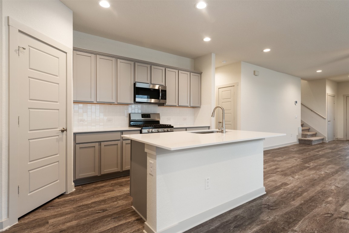 289 Deserti Road Leander, TX 78641 - Photo 6 of 19 a kitchen with kitchen island a sink stainless steel appliances and cabinets