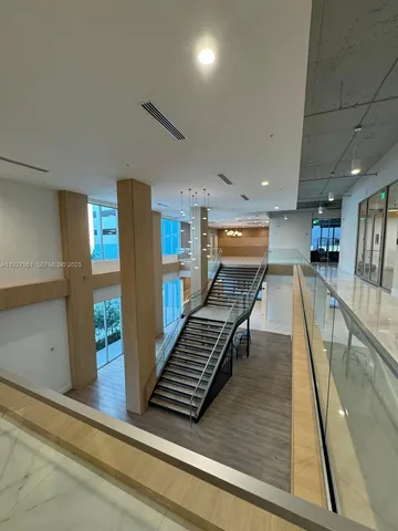 a kitchen with stainless steel appliances granite countertop a sink and a refrigerator