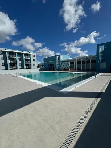 a view of a building with a tree in front