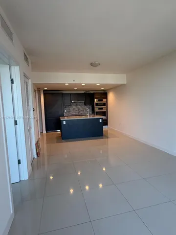 a hallway with a large mirror and a sink