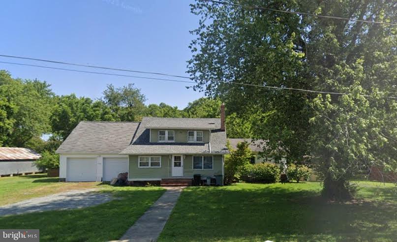 a view of a house with a big yard and large trees
