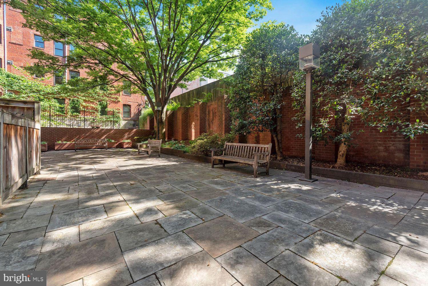 2320 Wisconsin Avenue Northwest, Unit 206 Washington, DC 20007 - Photo 18 of 32 a view of backyard with outdoor seating and trees