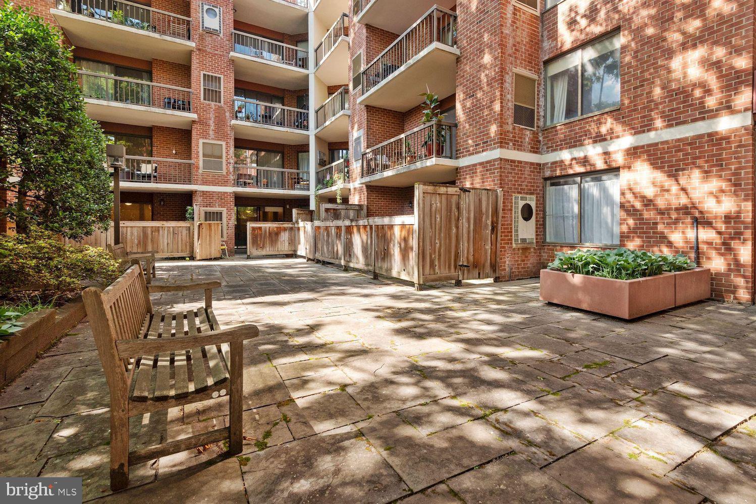 2320 Wisconsin Avenue Northwest, Unit 206 Washington, DC 20007 - Photo 19 of 32 a view of a building with a bench
