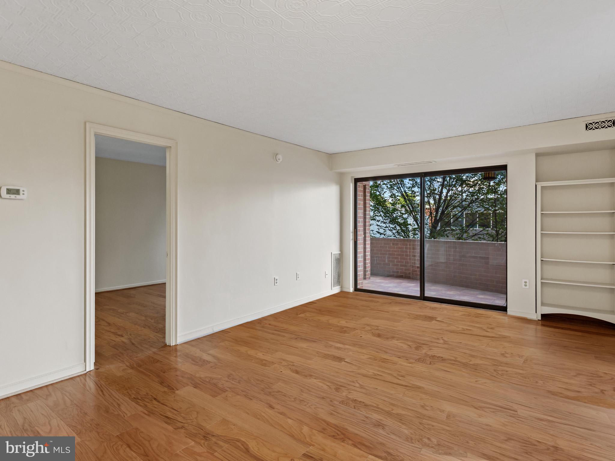 2320 Wisconsin Avenue Northwest, Unit 206 Washington, DC 20007 - Photo 4 of 32 a view of an empty room with a window