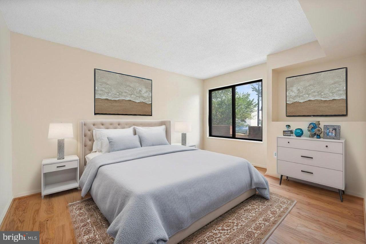 2320 Wisconsin Avenue Northwest, Unit 206 Washington, DC 20007 - Photo 8 of 32 a bedroom with a bed and a window