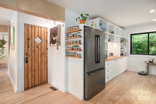 a kitchen with a refrigerator a sink and cabinets