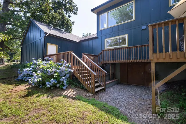 a view of a house with a wooden deck