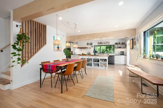 a dining room with furniture a rug and wooden floor