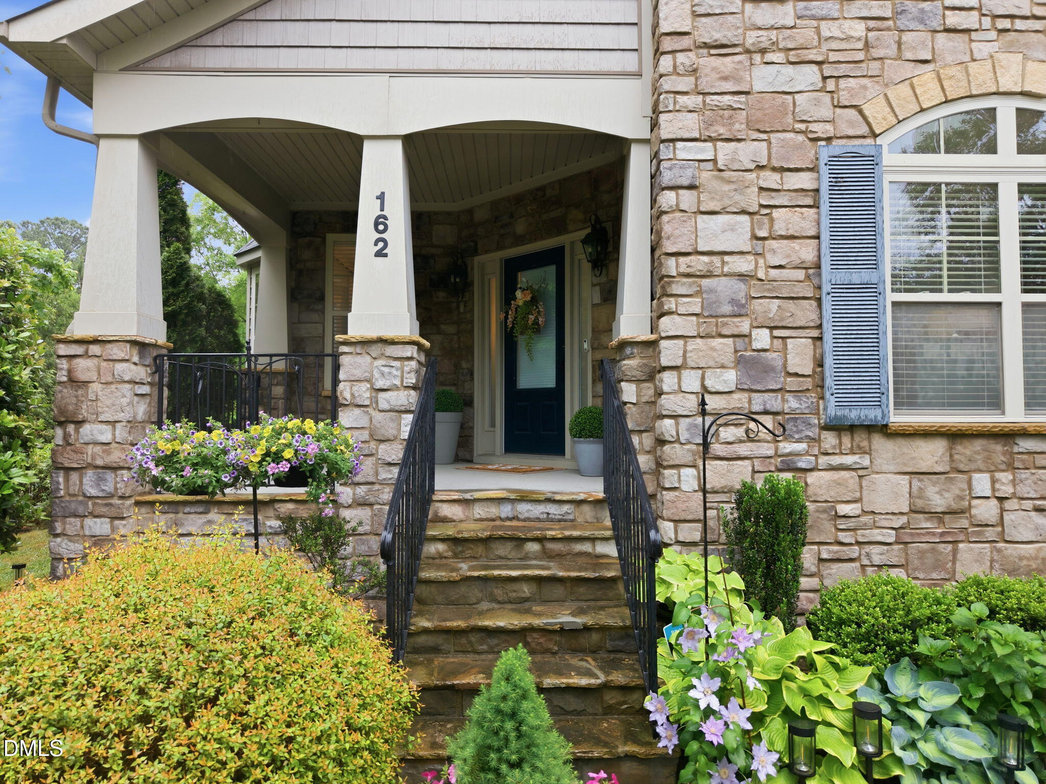 162 Gathering Place Durham, NC 27713 - Photo 41 of 52 a front view of a house with a garden