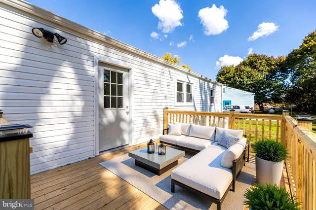 a balcony with furniture and a potted plant