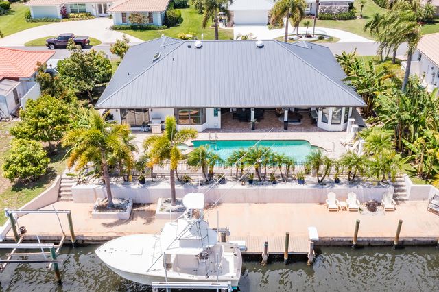a aerial view of a house with table and chairs under an umbrella