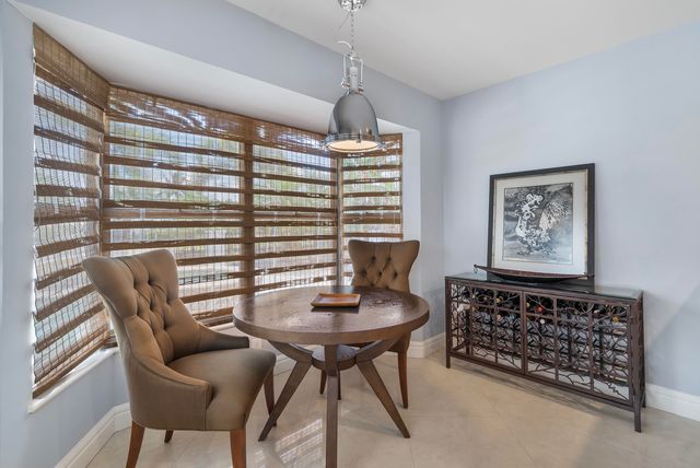 a kitchen with kitchen island granite countertop a sink and a stove
