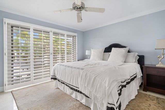 a living room with furniture and a ceiling fan