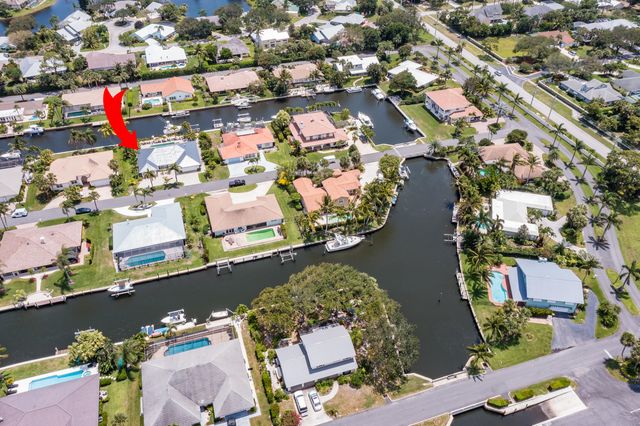 a view of a garden with a bench and lawn chairs
