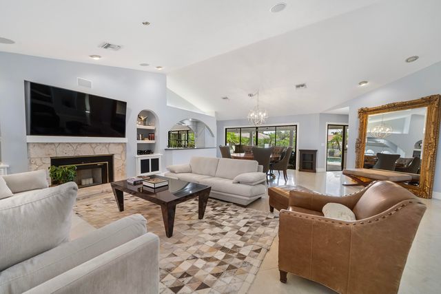 a view of a dining room with furniture a rug and wooden floor