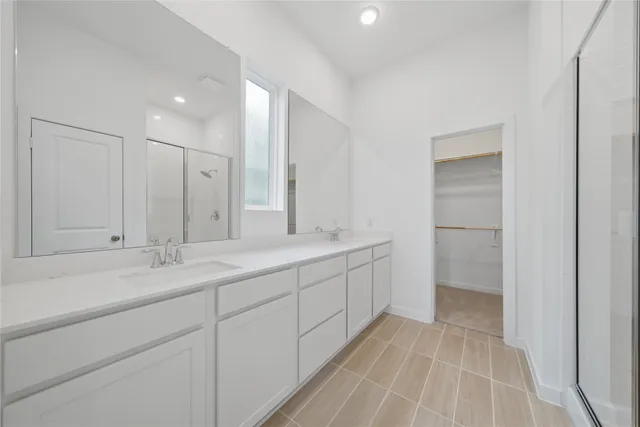 a bathroom with a double vanity sink and mirror