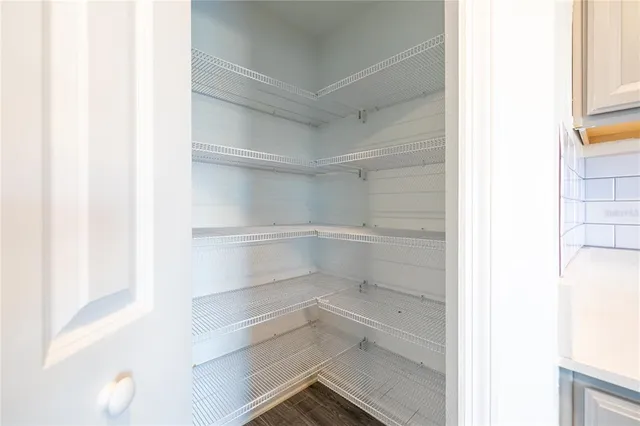 a view of walk in closet with empty racks