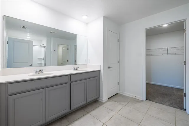 a bathroom with a double vanity sink and a mirror