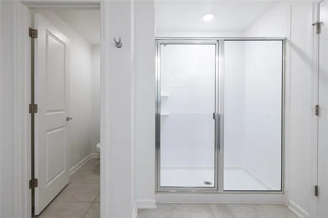 a bathroom with a glass shower door