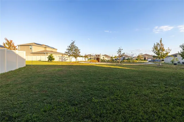 a backyard of a house with lots of green space