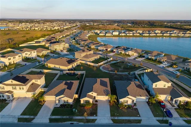 an aerial view of residential houses with outdoor space