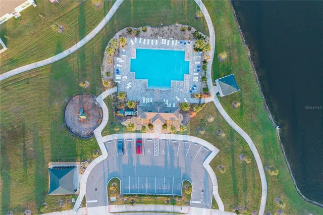 a view of swimming pool with lounge chairs in patio