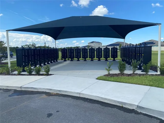 a view of a garden with a table and chairs under an umbrella