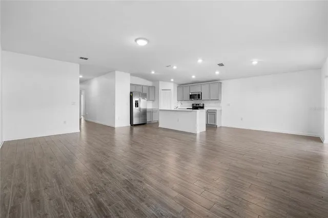 a view of kitchen with refrigerator stove microwave and cabinets