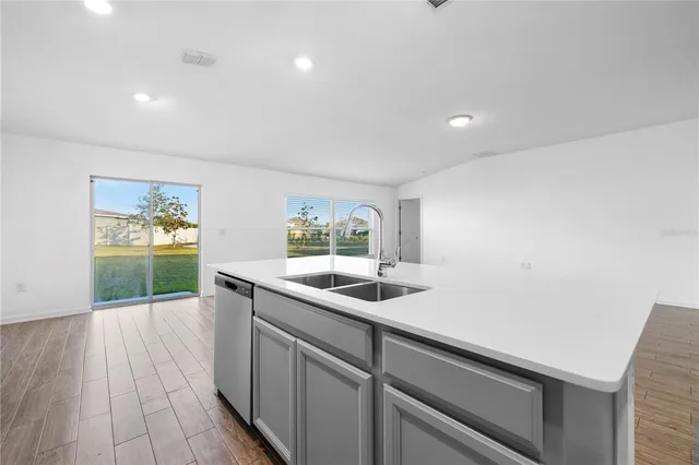 a kitchen with a sink and large window