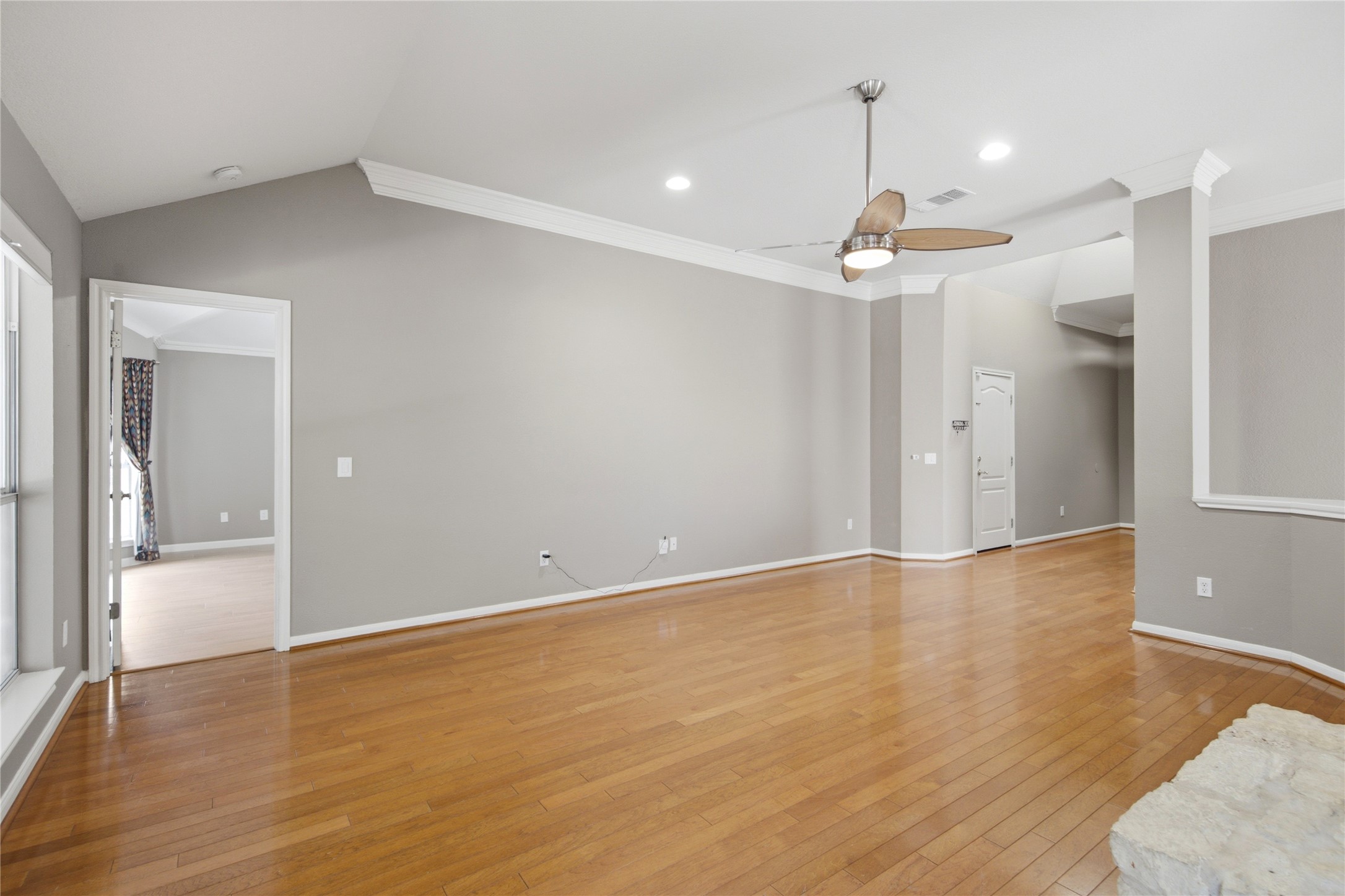 6032 Roxbury Lane Austin, TX 78739 - Photo 9 of 34 Polished wood floors and clean crown molding accent this open living area.