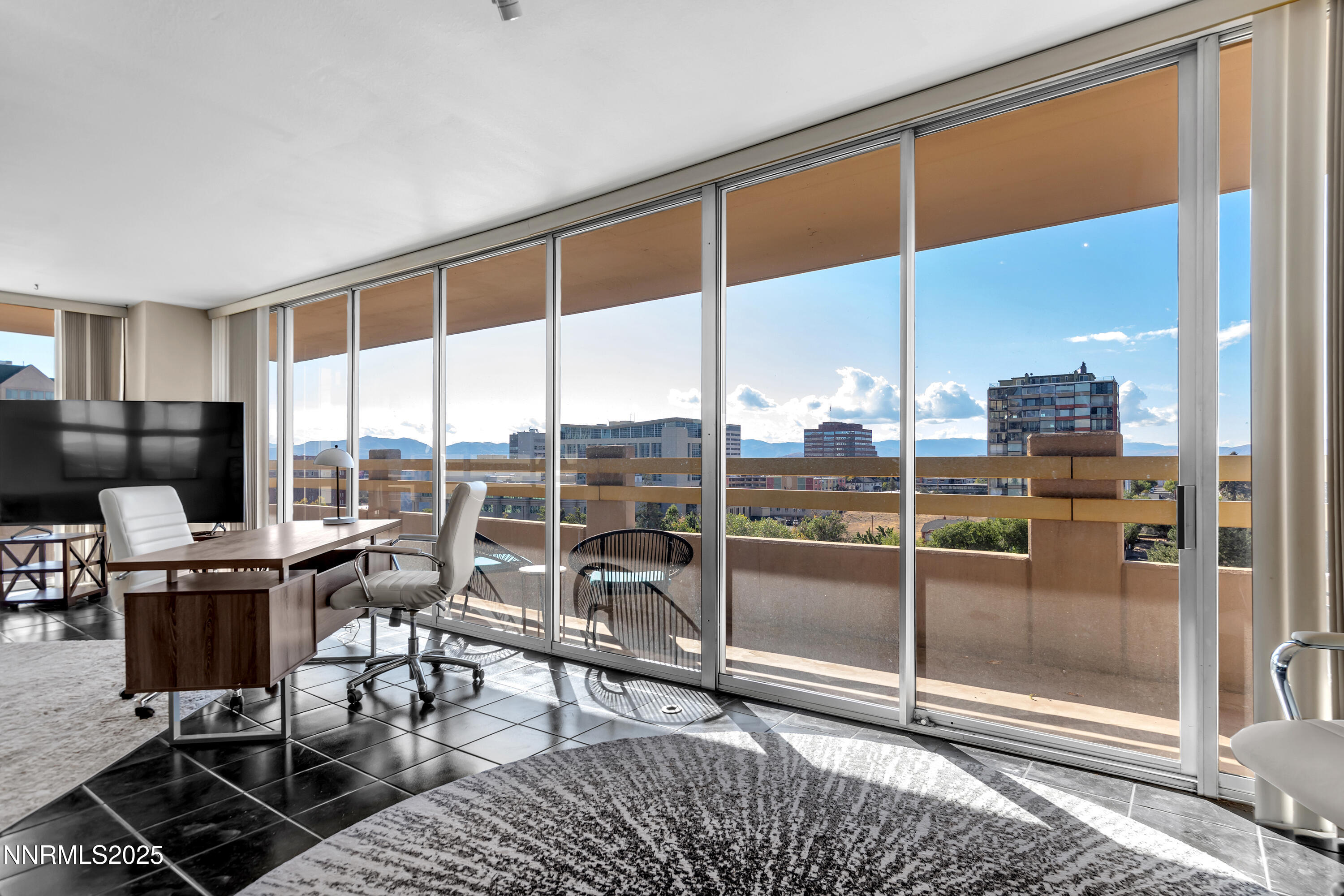 a room with gym equipment and large windows