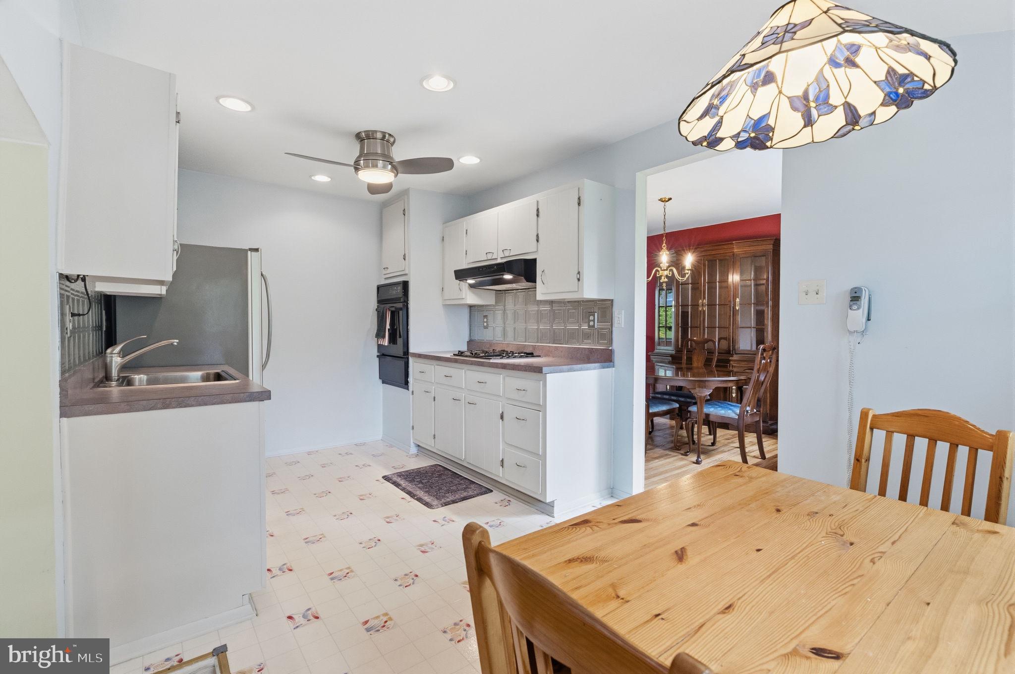 81 Cherokee Road Doylestown, PA 18901 - Photo 8 of 43 a kitchen with a table chairs refrigerator and microwave