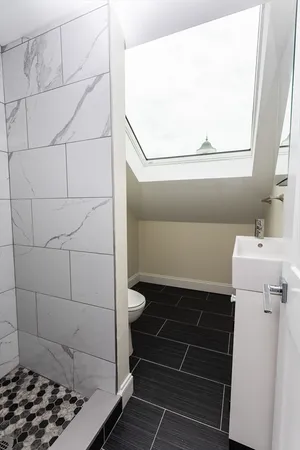 a bathroom with a sink toilet and shower