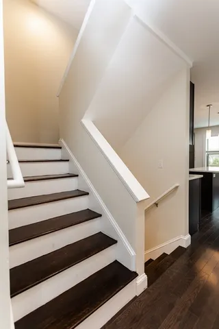 a view of entryway with wooden floor and stairs