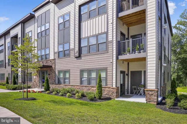 front view of a brick house with a yard