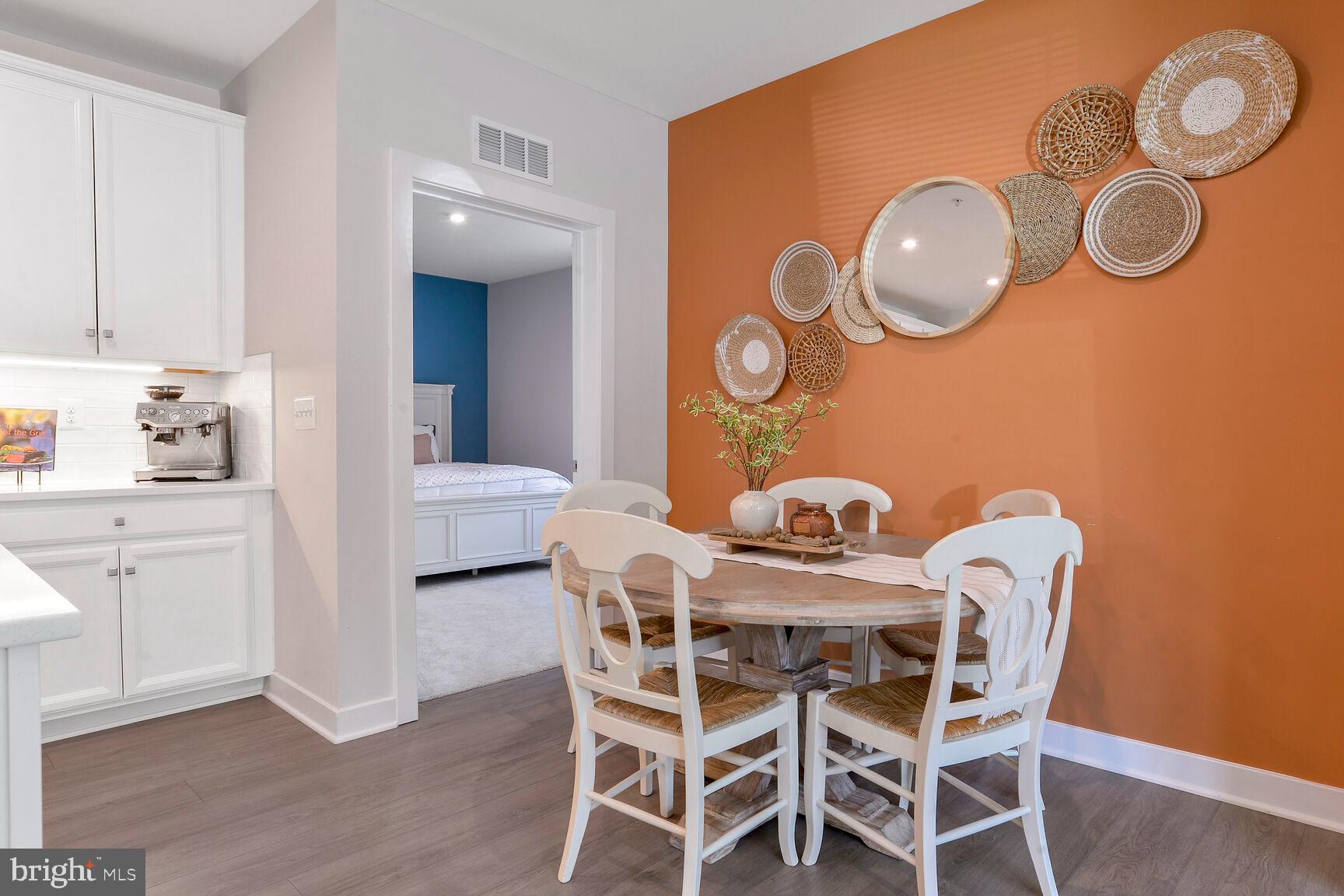 10401 Resort Road, Unit E Ellicott City, MD 21042 - Photo 11 of 44 a view of a dining room with furniture and wooden floor