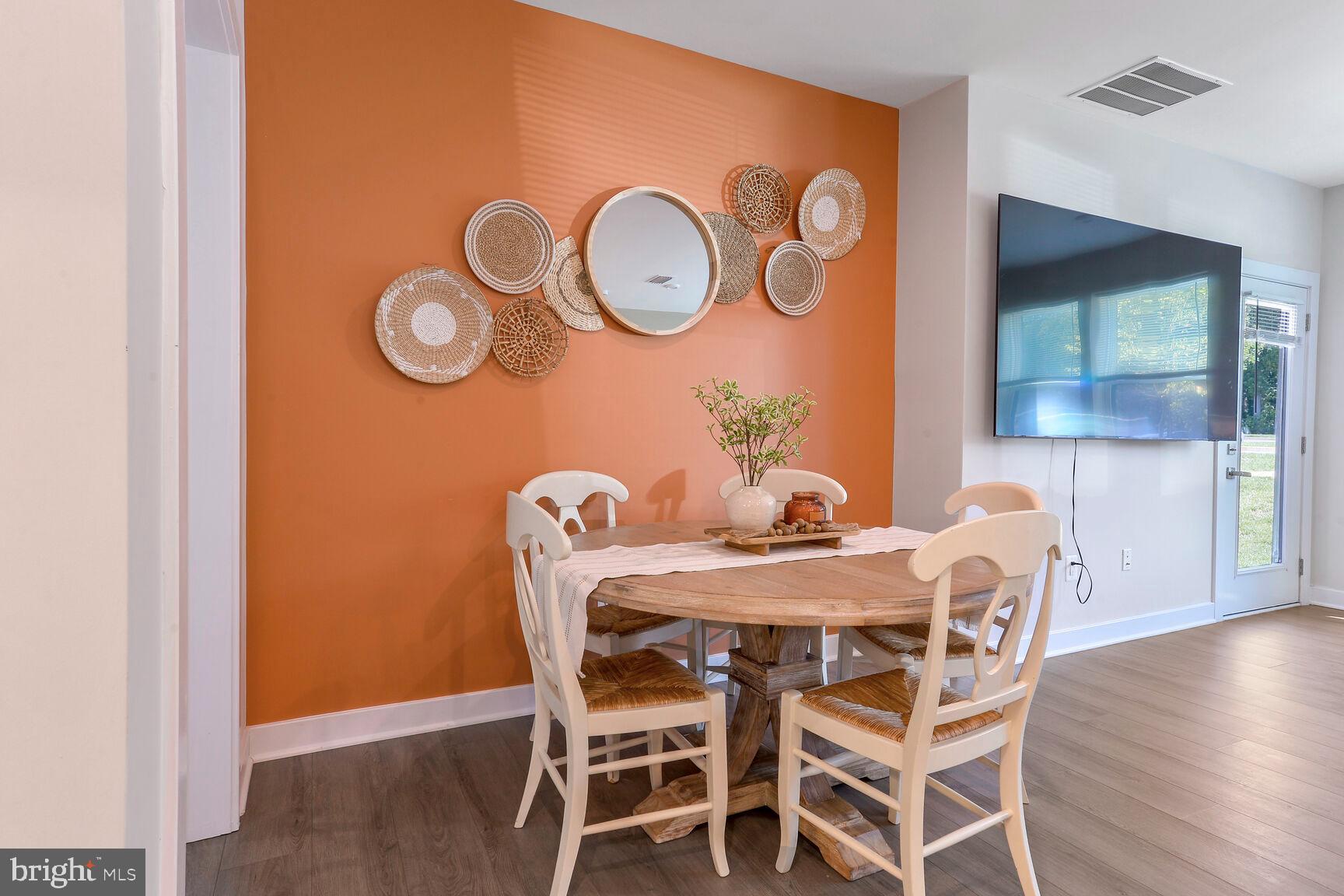 10401 Resort Road, Unit E Ellicott City, MD 21042 - Photo 13 of 44 a dining room with furniture and wooden floor