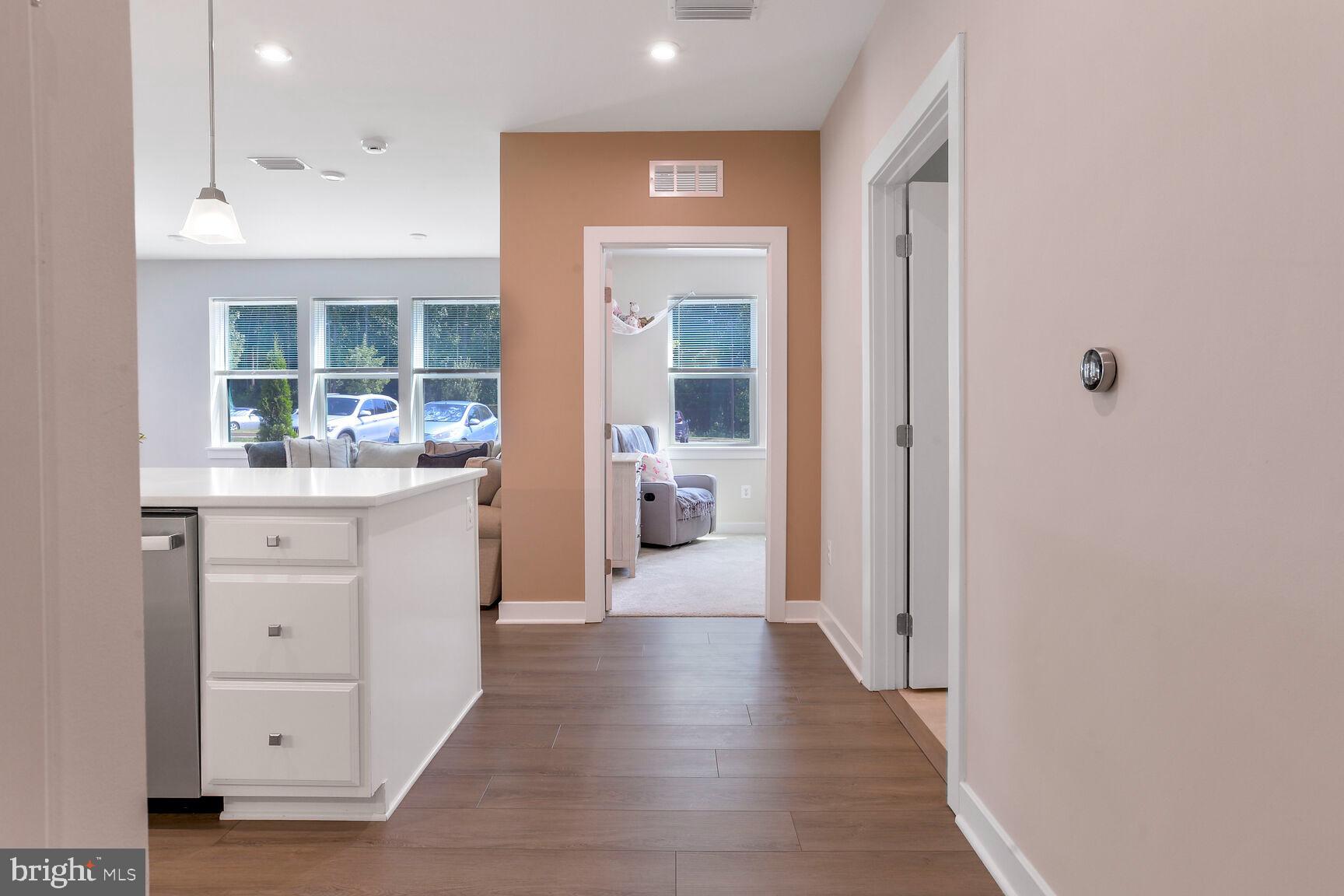 10401 Resort Road, Unit E Ellicott City, MD 21042 - Photo 15 of 44 a hallway with white cabinets and wooden floor