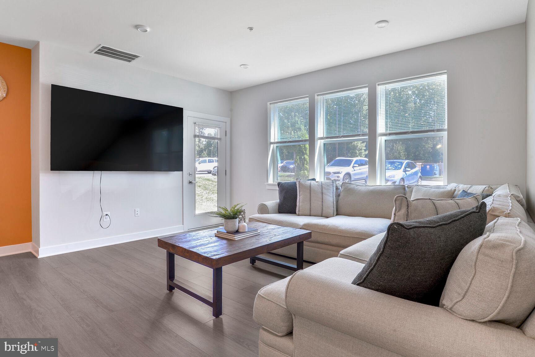 10401 Resort Road, Unit E Ellicott City, MD 21042 - Photo 19 of 44 a living room with furniture and a flat screen tv
