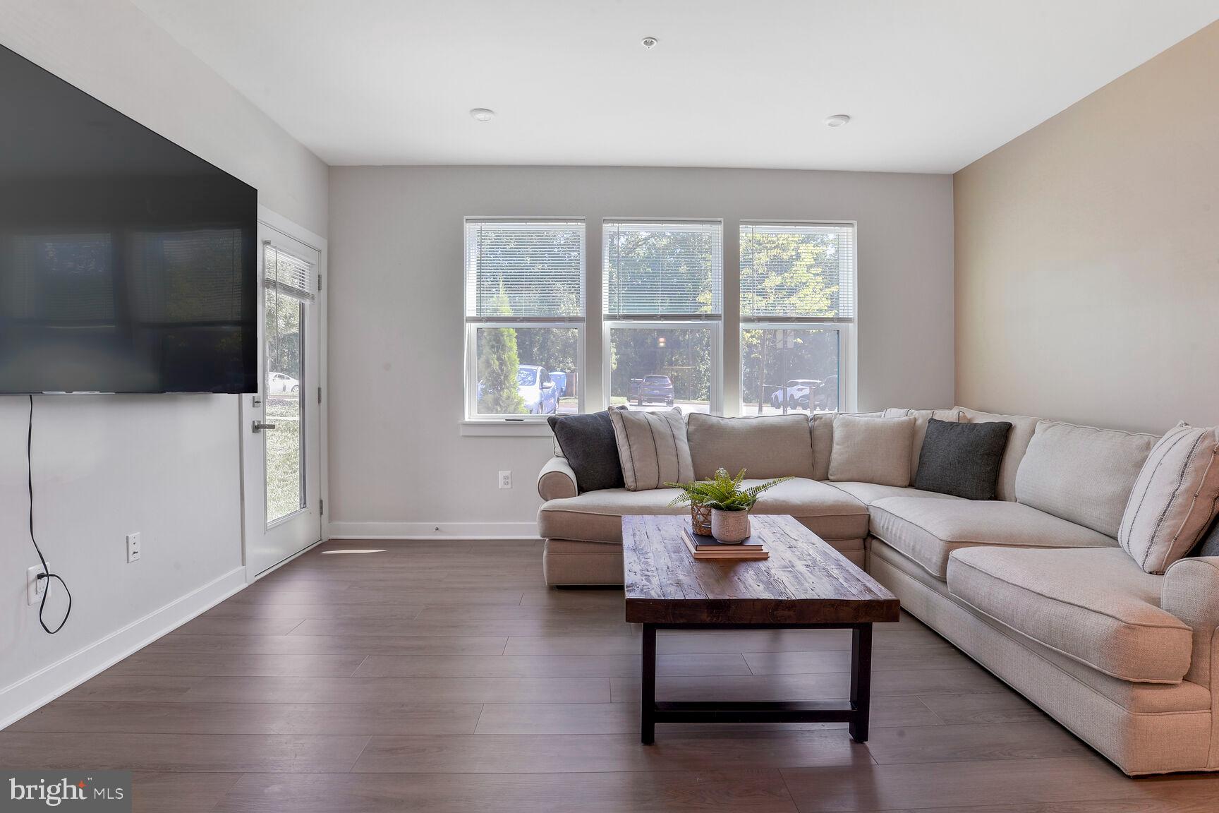 10401 Resort Road, Unit E Ellicott City, MD 21042 - Photo 21 of 44 a living room with furniture and a flat screen tv