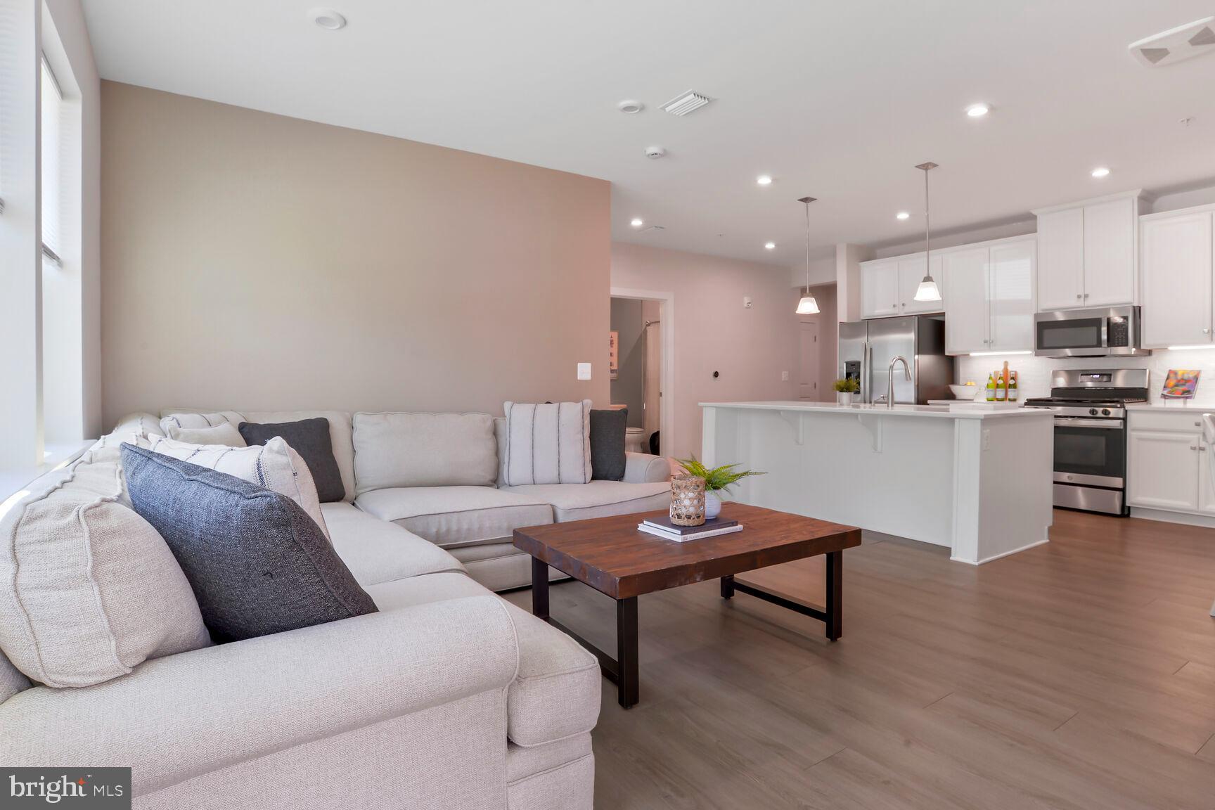 10401 Resort Road, Unit E Ellicott City, MD 21042 - Photo 23 of 44 a living room with furniture and kitchen view