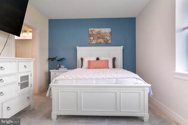 a spacious bedroom with a bed and a cabinets