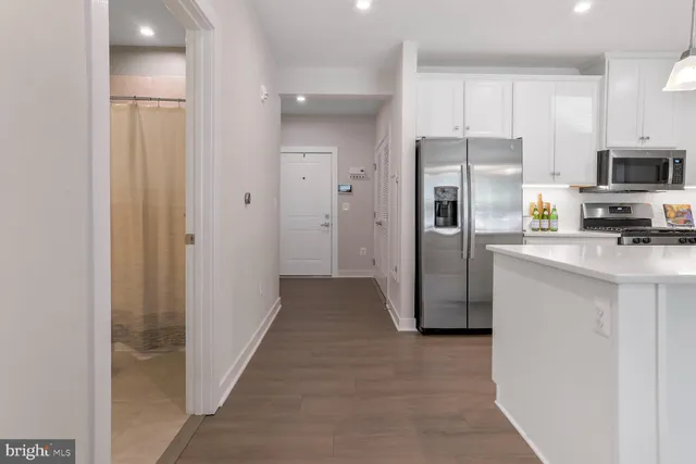 a kitchen with stainless steel appliances a refrigerator sink and microwave