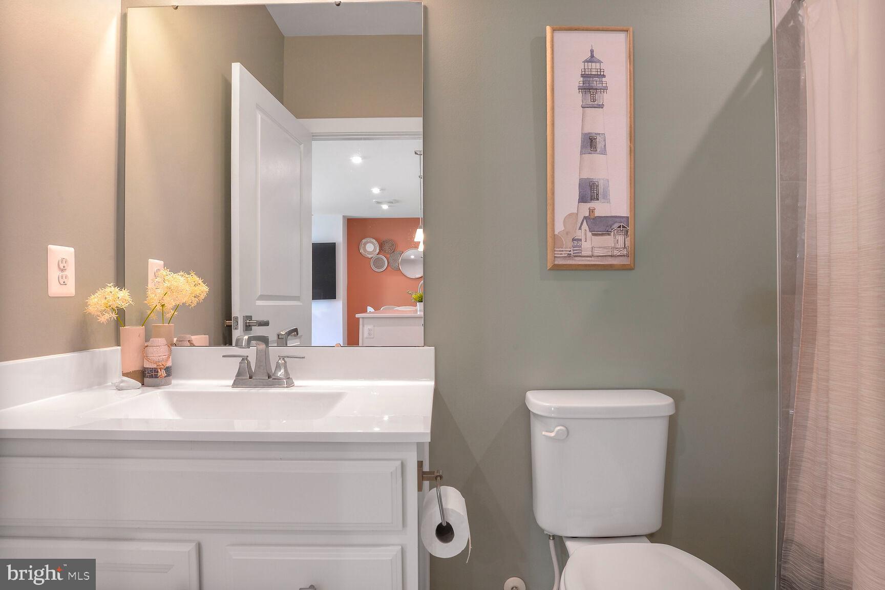 10401 Resort Road, Unit E Ellicott City, MD 21042 - Photo 33 of 44 a bathroom with a toilet sink and mirror