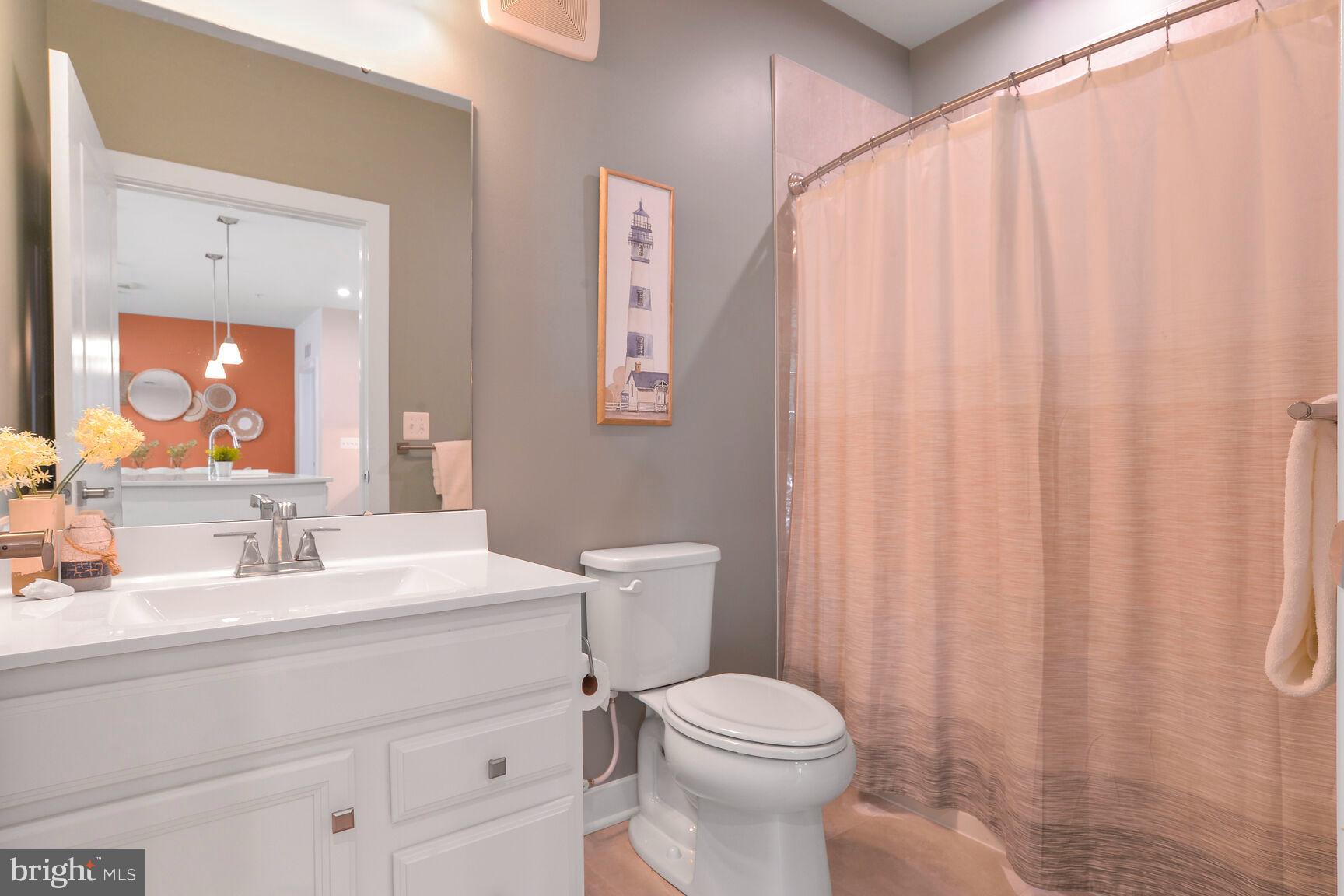 10401 Resort Road, Unit E Ellicott City, MD 21042 - Photo 34 of 44 a bathroom with a toilet a sink and a mirror